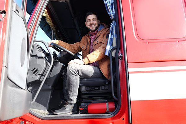 driver in red truck smiling